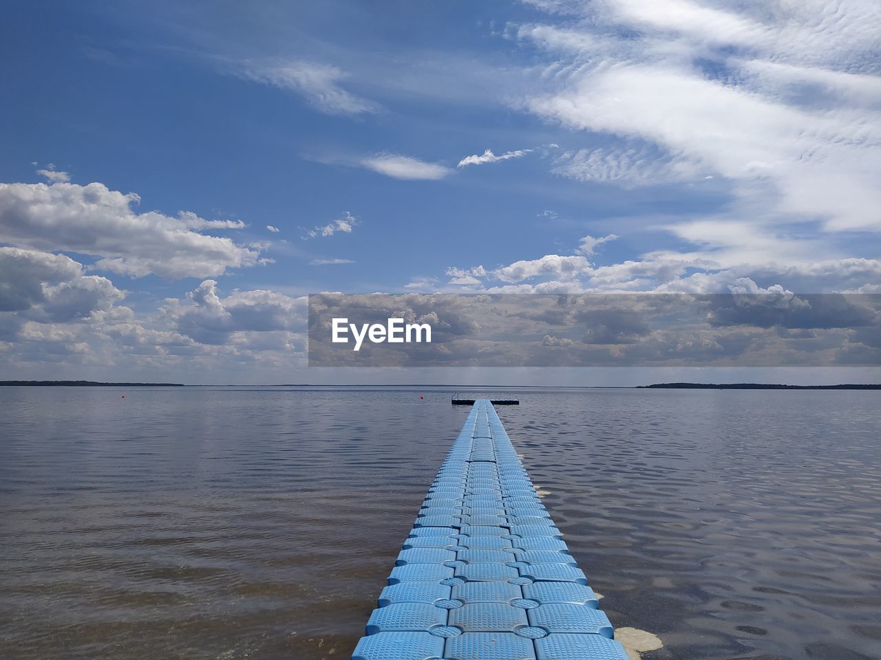 VIEW OF PIER OVER SEA AGAINST CLOUDY SKY