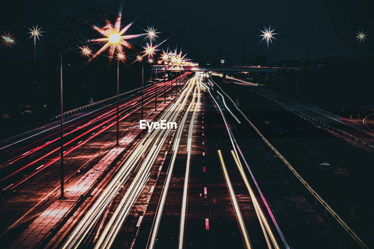 High angle view of light trails on road at night