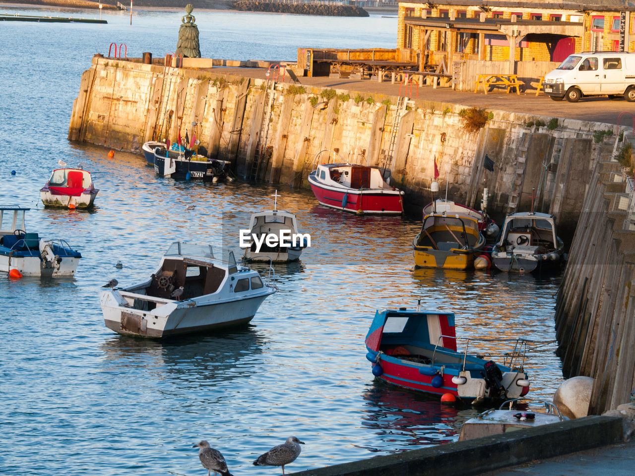 BOATS MOORED IN SEA