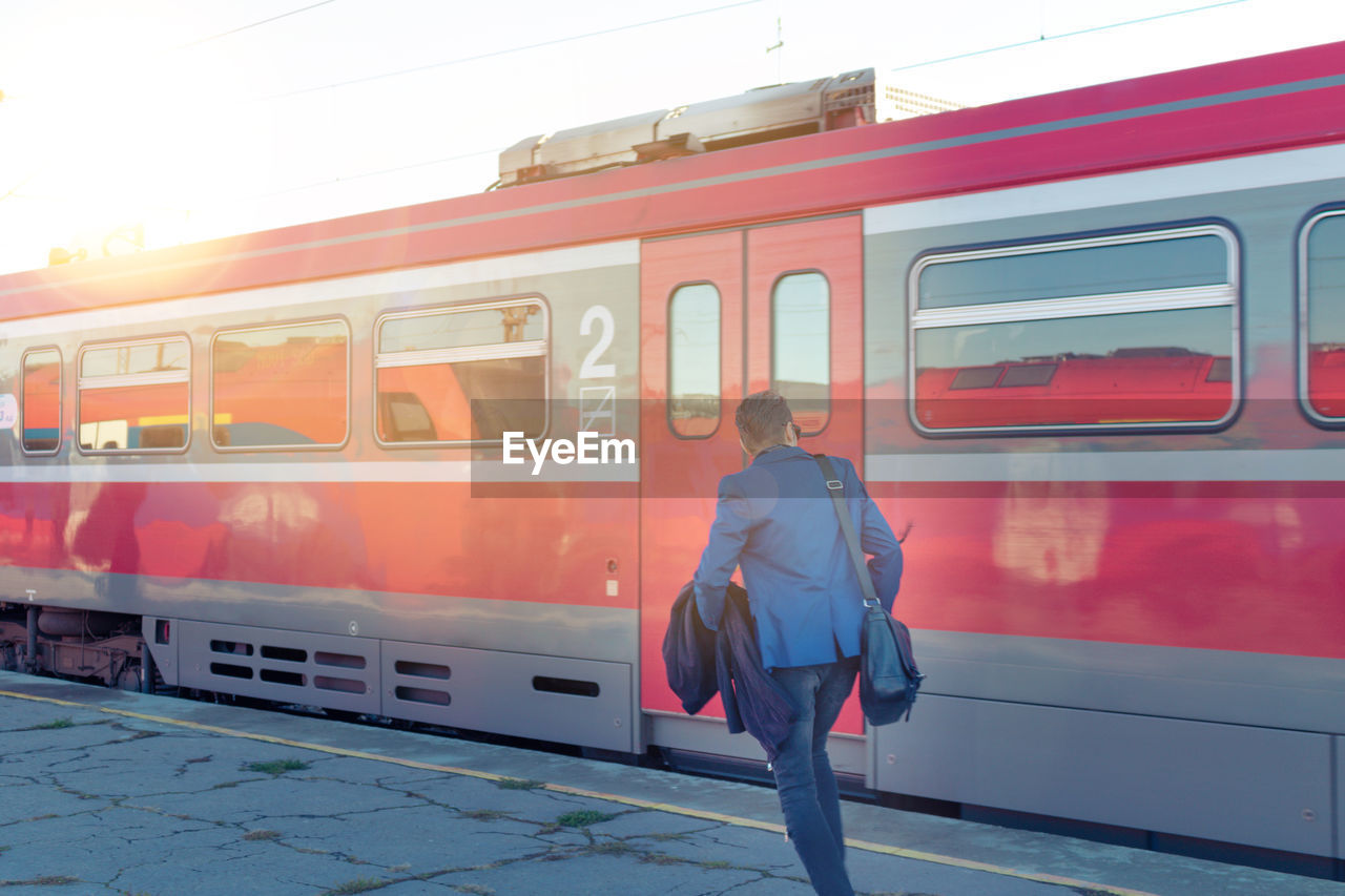 Rear view of woman on train at railroad station