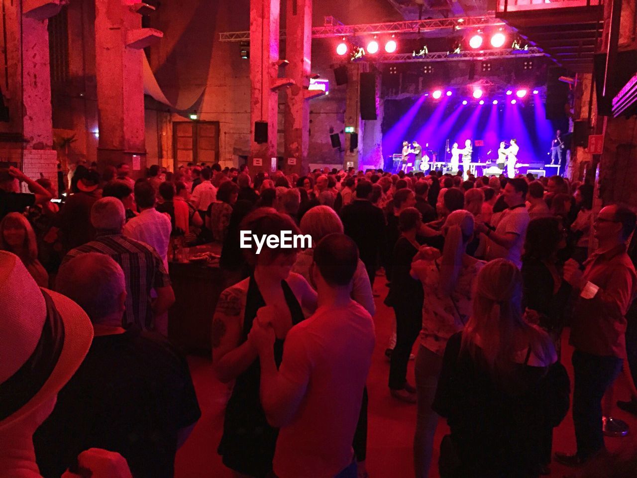 REAR VIEW OF PEOPLE ENJOYING IN CONCERT