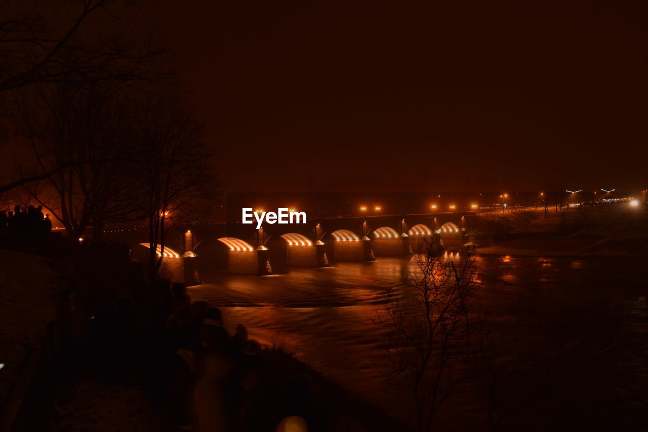 VIEW OF ILLUMINATED BRIDGE AT NIGHT