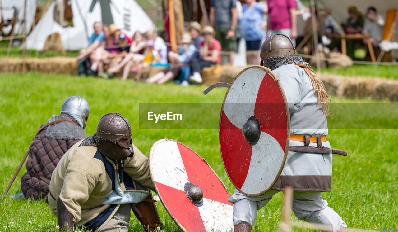 Show fight of medieval knights on a battlefield at the medieval market spectacle