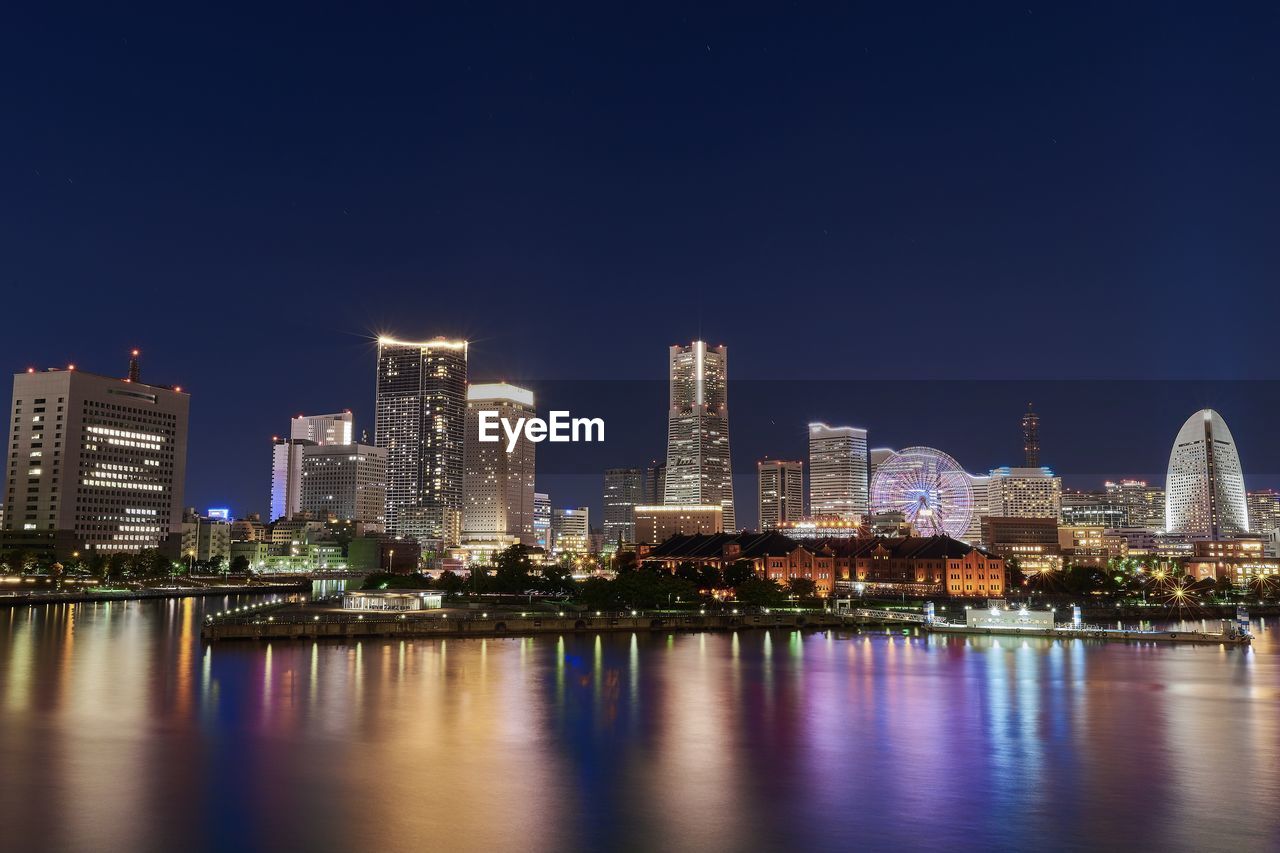 Illuminated city at waterfront