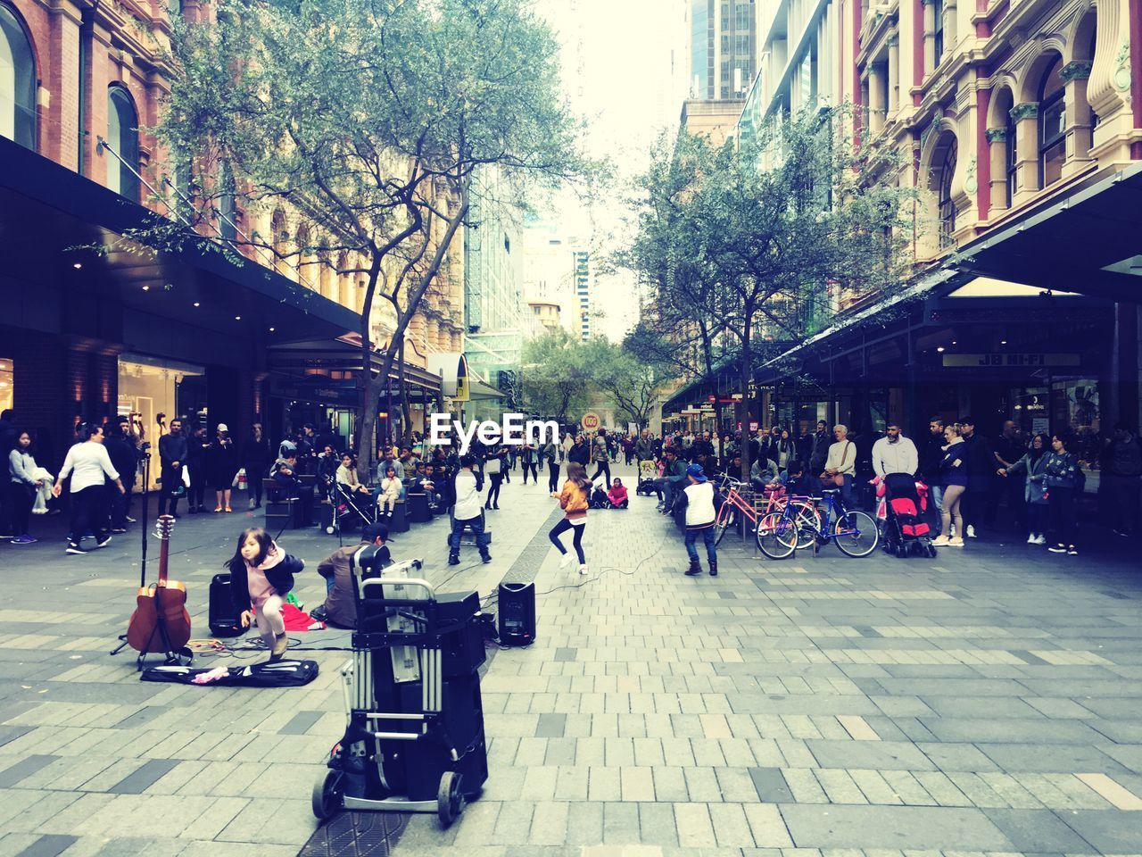 PEOPLE SITTING ON SIDEWALK