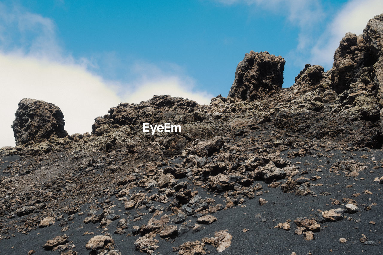 rock, sky, mountain, cloud, nature, environment, landscape, land, scenics - nature, geology, beauty in nature, no people, travel destinations, rock formation, soil, outdoors, non-urban scene, travel, sea, volcano, ridge, day, tranquility, wilderness, summit, physical geography, plateau, blue, volcanic rock