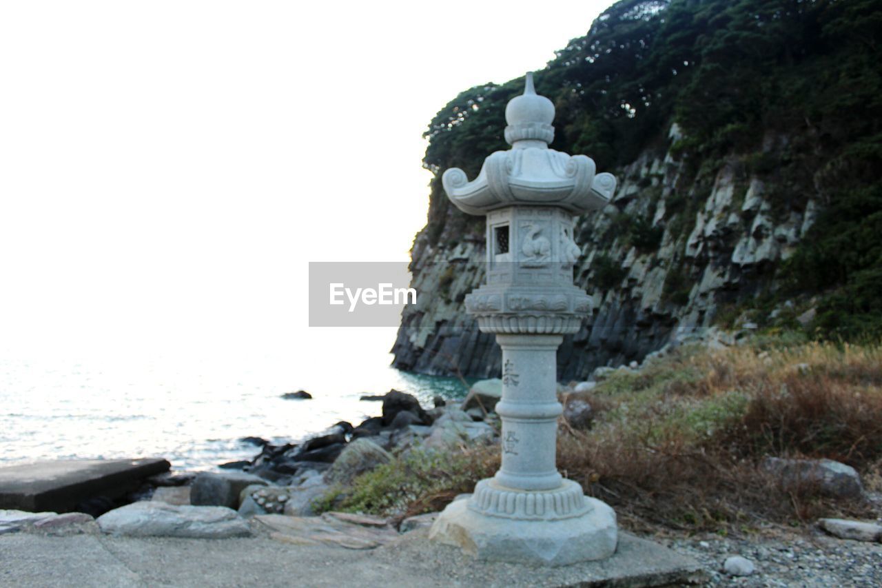 STATUE OF TEMPLE AGAINST CLEAR SKY