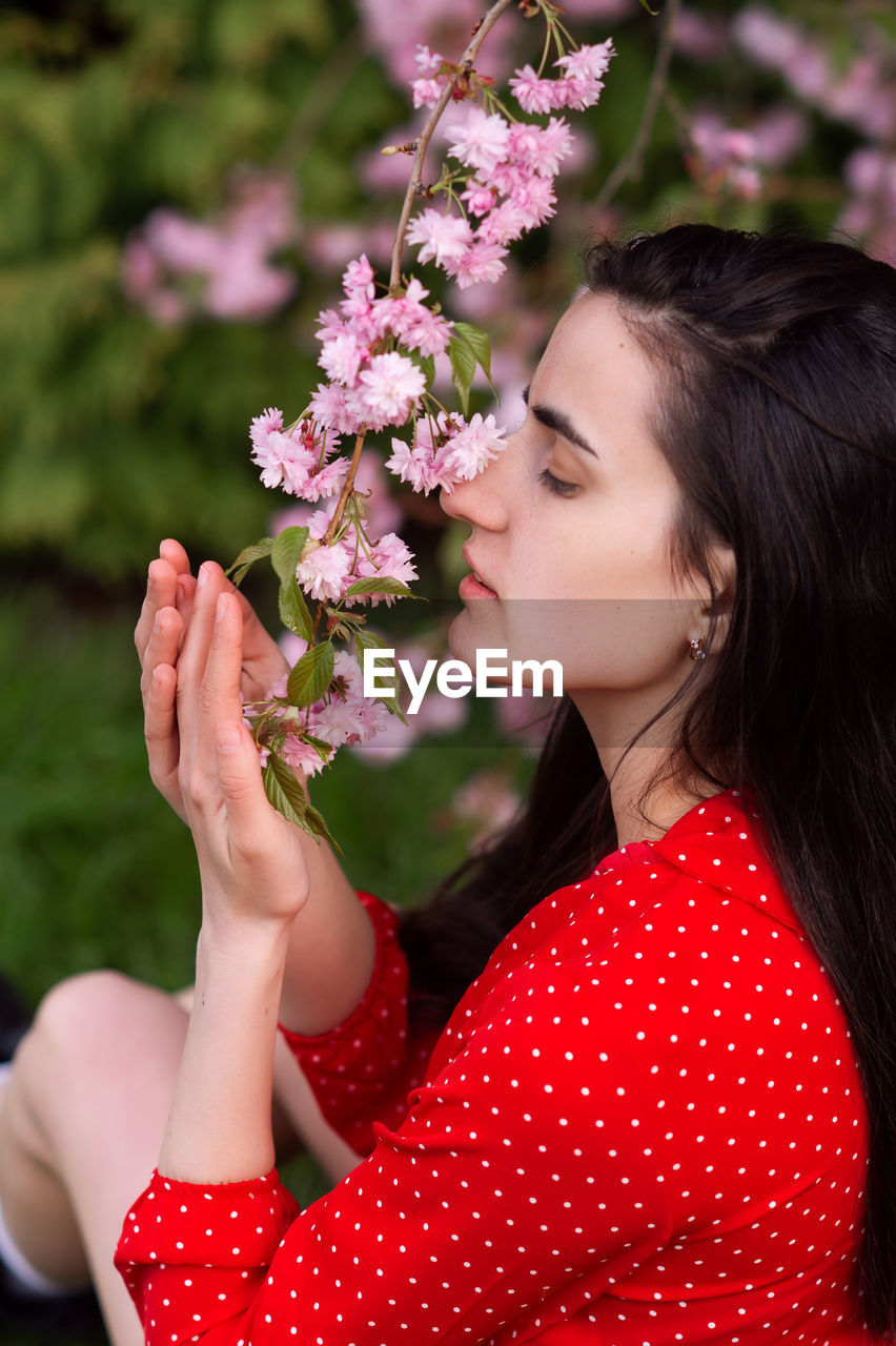 Botanical garden, young girl, sweet woman, leather jacket, flowering trees, flowers on a tree