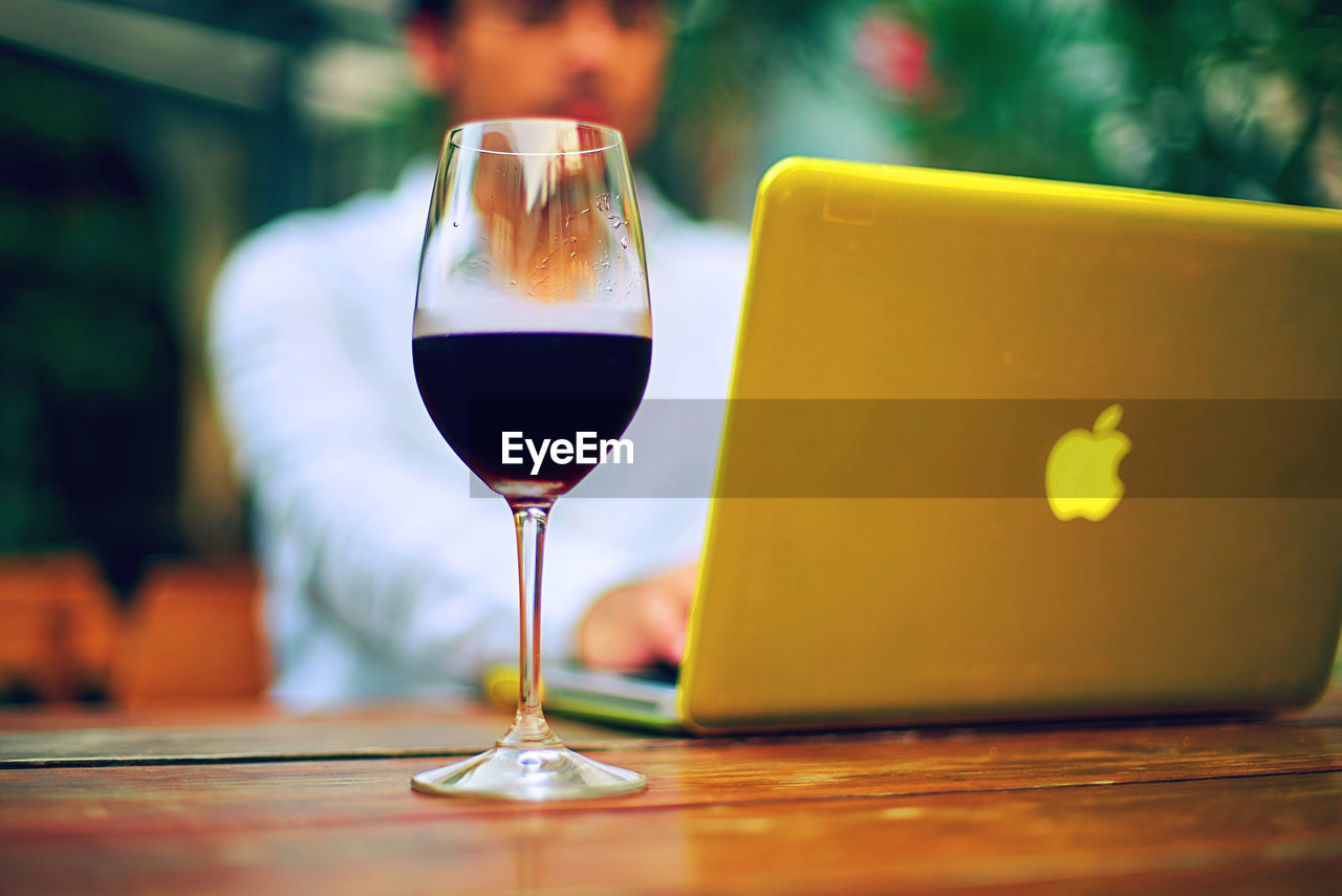 CLOSE-UP OF WINEGLASS ON TABLE IN RESTAURANT