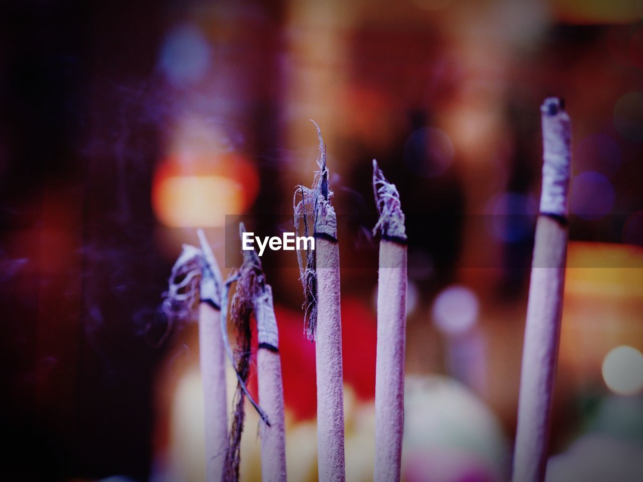 Close-up of burning candles in temple