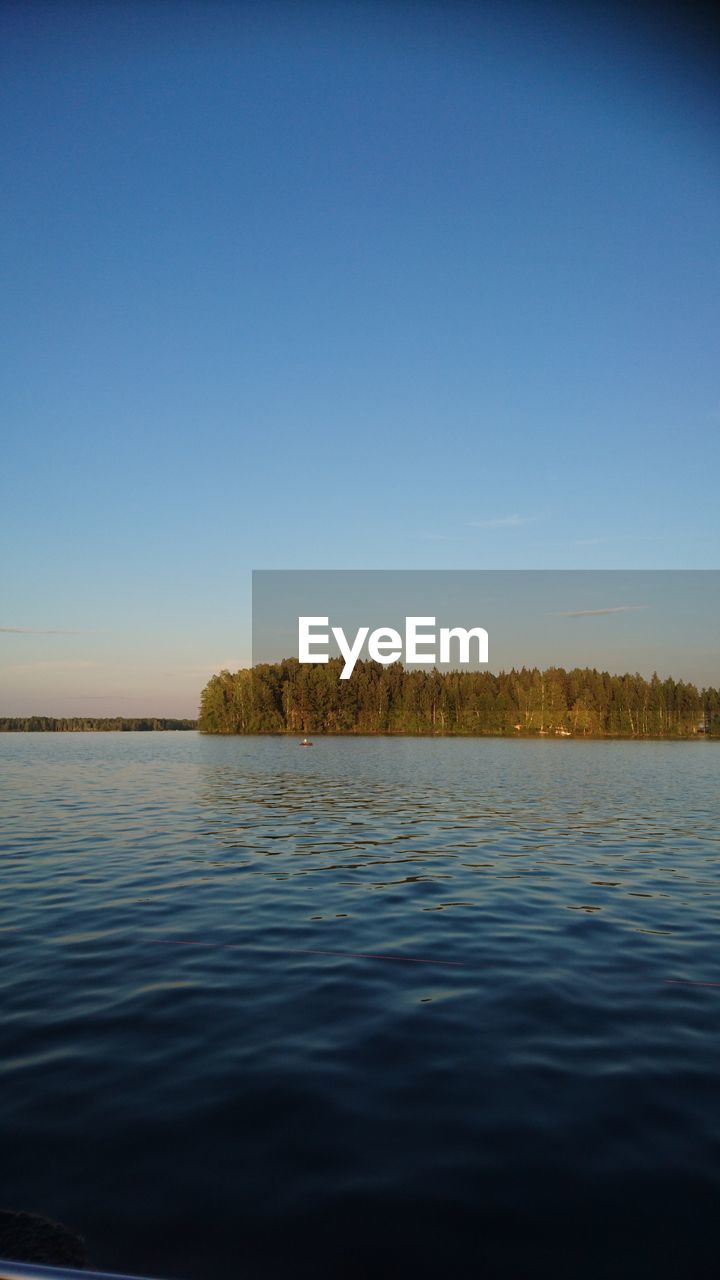 VIEW OF LAKE AGAINST CLEAR BLUE SKY