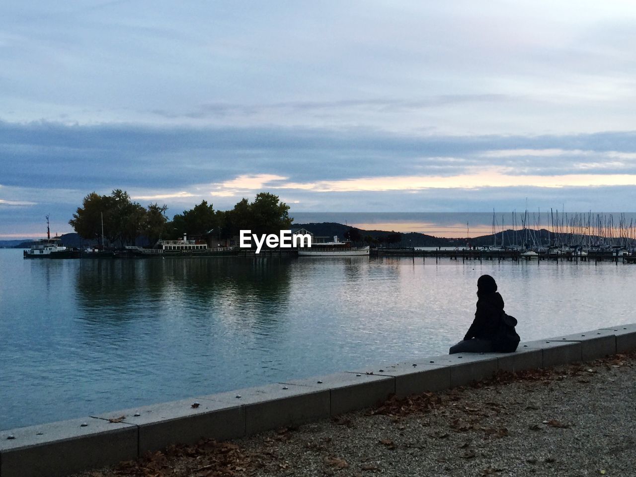 SCENIC VIEW OF LAKE AT SUNSET