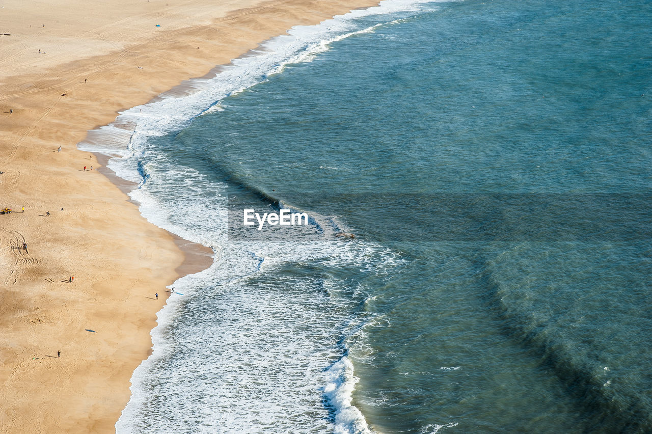 HIGH ANGLE VIEW OF SUNLIGHT FALLING ON SEA SHORE