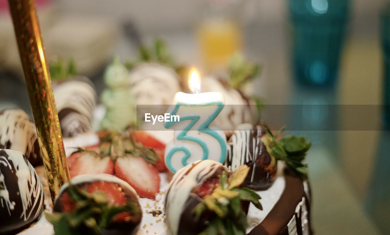 candle, celebration, food, food and drink, event, party, no people, sweet, sweet food, selective focus, tradition, close-up, birthday cake, burning, decoration, holiday, indoors, dessert, focus on foreground, sweetness, fire, birthday, nature, meal, anniversary, still life, text, cake