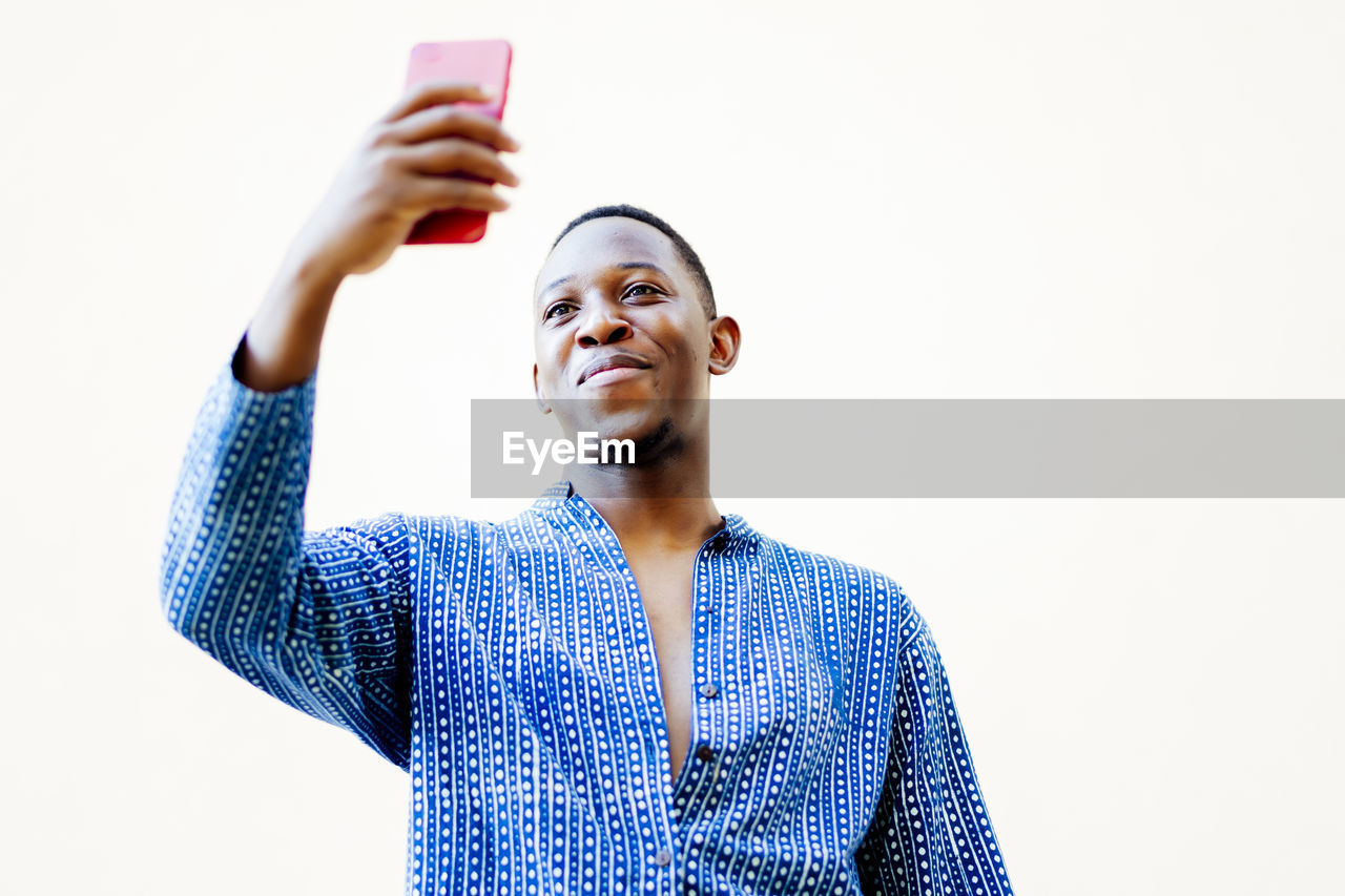 Young african man making a selfie with his smartphone