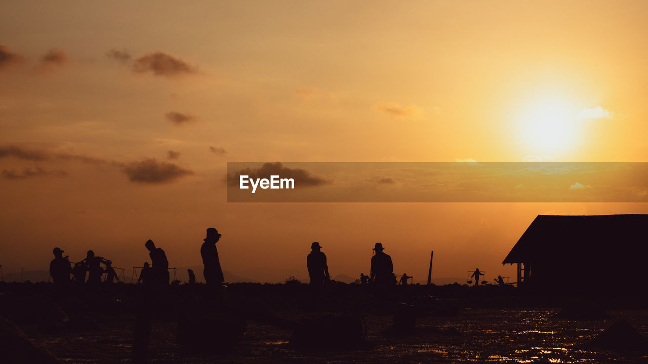 SILHOUETTE PEOPLE AT BEACH DURING SUNSET