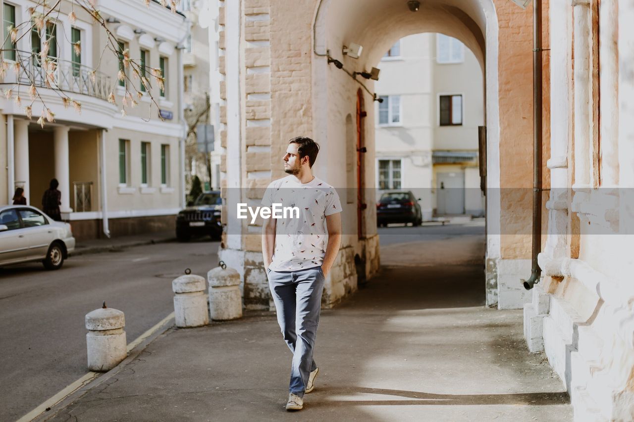 MAN STANDING IN BUILDING