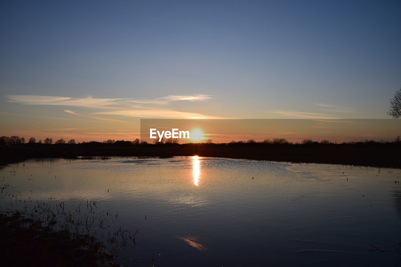 SCENIC VIEW OF LAKE DURING SUNSET