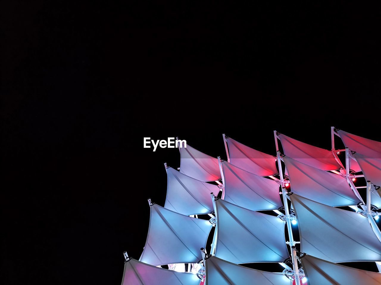 LOW ANGLE VIEW OF MULTI COLORED FLAGS AGAINST CLEAR SKY