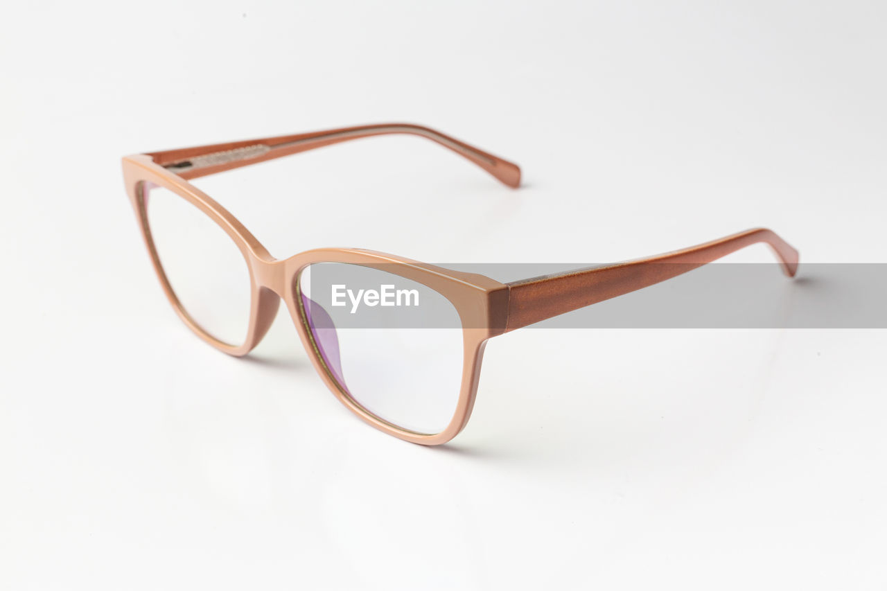 A beautiful pair of eye glasses isolated in white background - optical medical classic beige frame