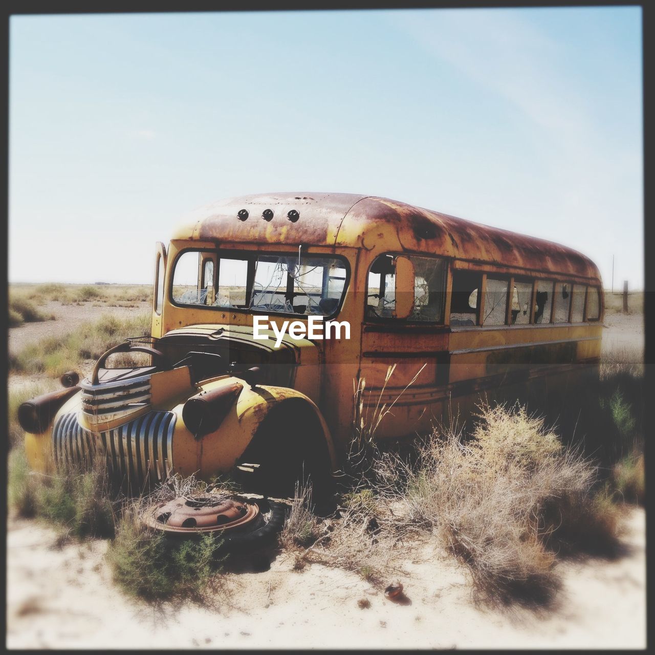 Abandoned bus on field against sky