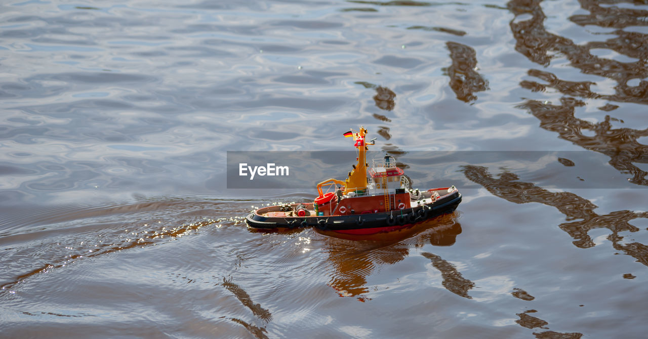 Remote controlled ship model is remote controlled on a lake