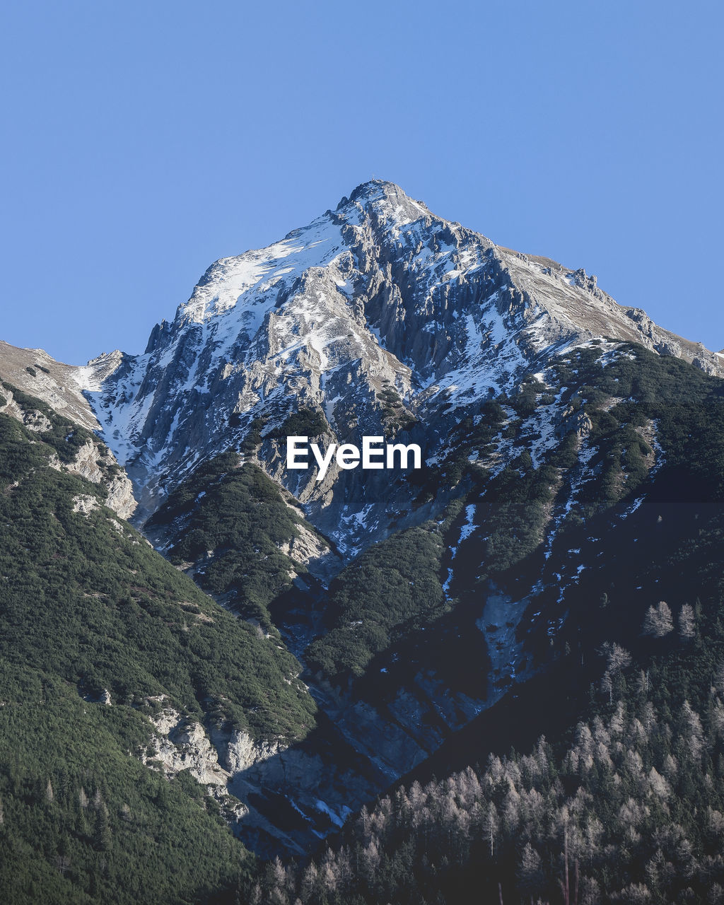 Low angle view of mountains against clear blue sky