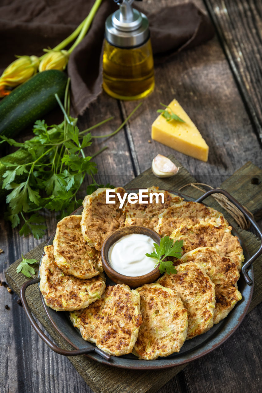 Healthy summer food, zucchini fritters. vegetarian zucchini pancakes with cheese. 