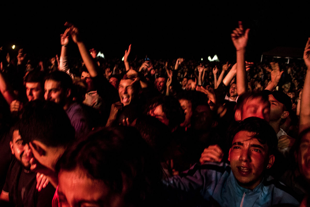 crowd, arts culture and entertainment, group of people, audience, music, enjoyment, large group of people, event, performance, night, arm, arms raised, nightlife, rock concert, musical theatre, fun, concert, popular music concert, emotion, social group, atmosphere, fanatic, men, excitement, positive emotion, festival, young adult, adult, limb, human limb, looking, happiness, music festival, cheering, party, musician, cheerful, stage, youth culture, celebration, performance art, rock music, live event, women, carefree, togetherness, vitality, dancing, hand, performing arts event, lifestyles, indoors, nightclub, watching, leisure activity