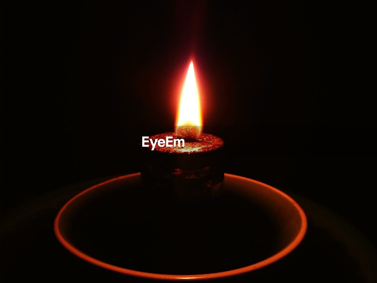 CLOSE-UP OF LIT CANDLE