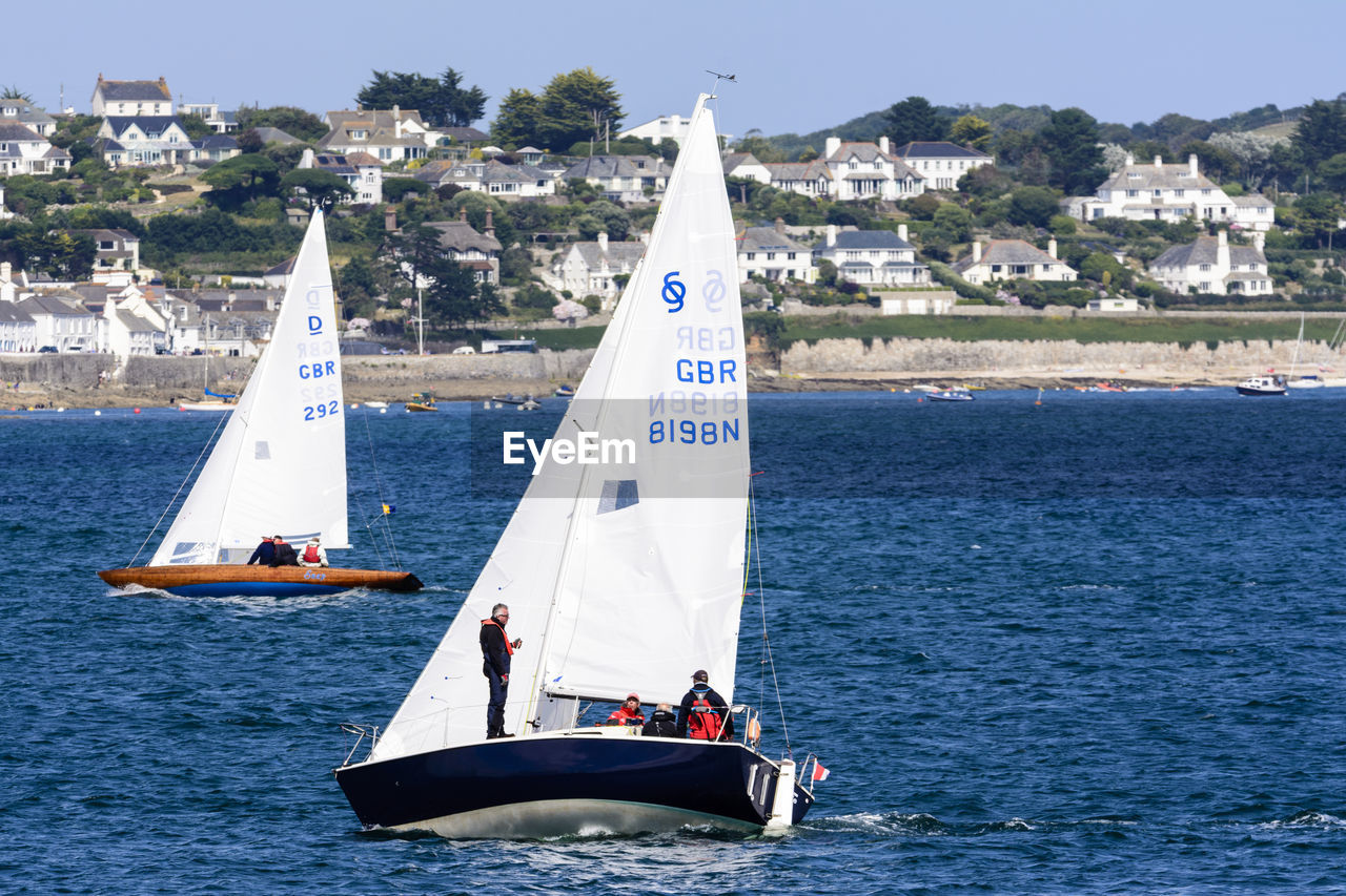 SAILBOATS SAILING IN SEA