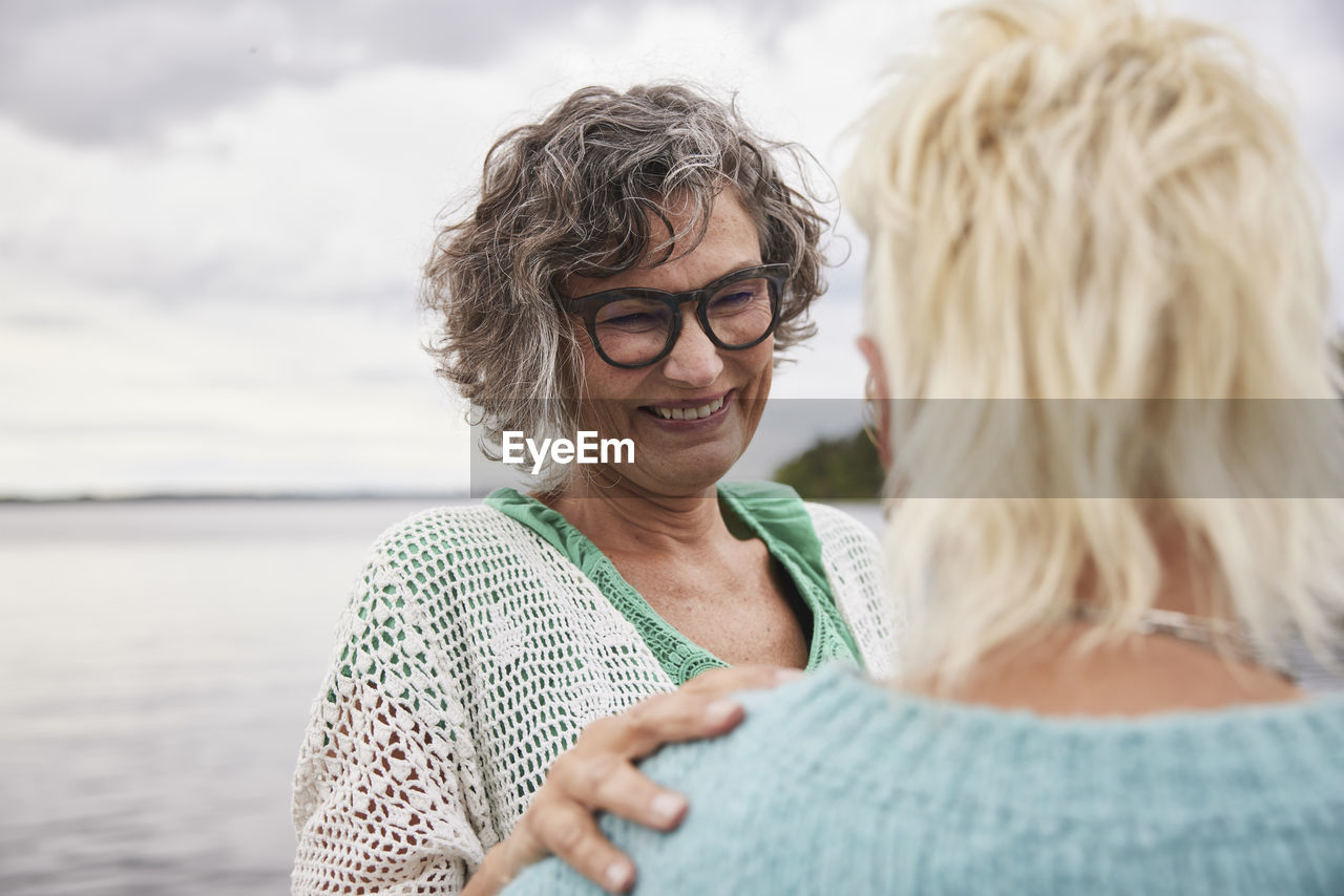 Smiling woman talking to friend