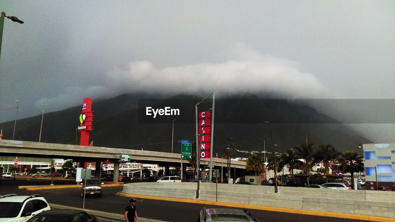 Road by mountain against sky