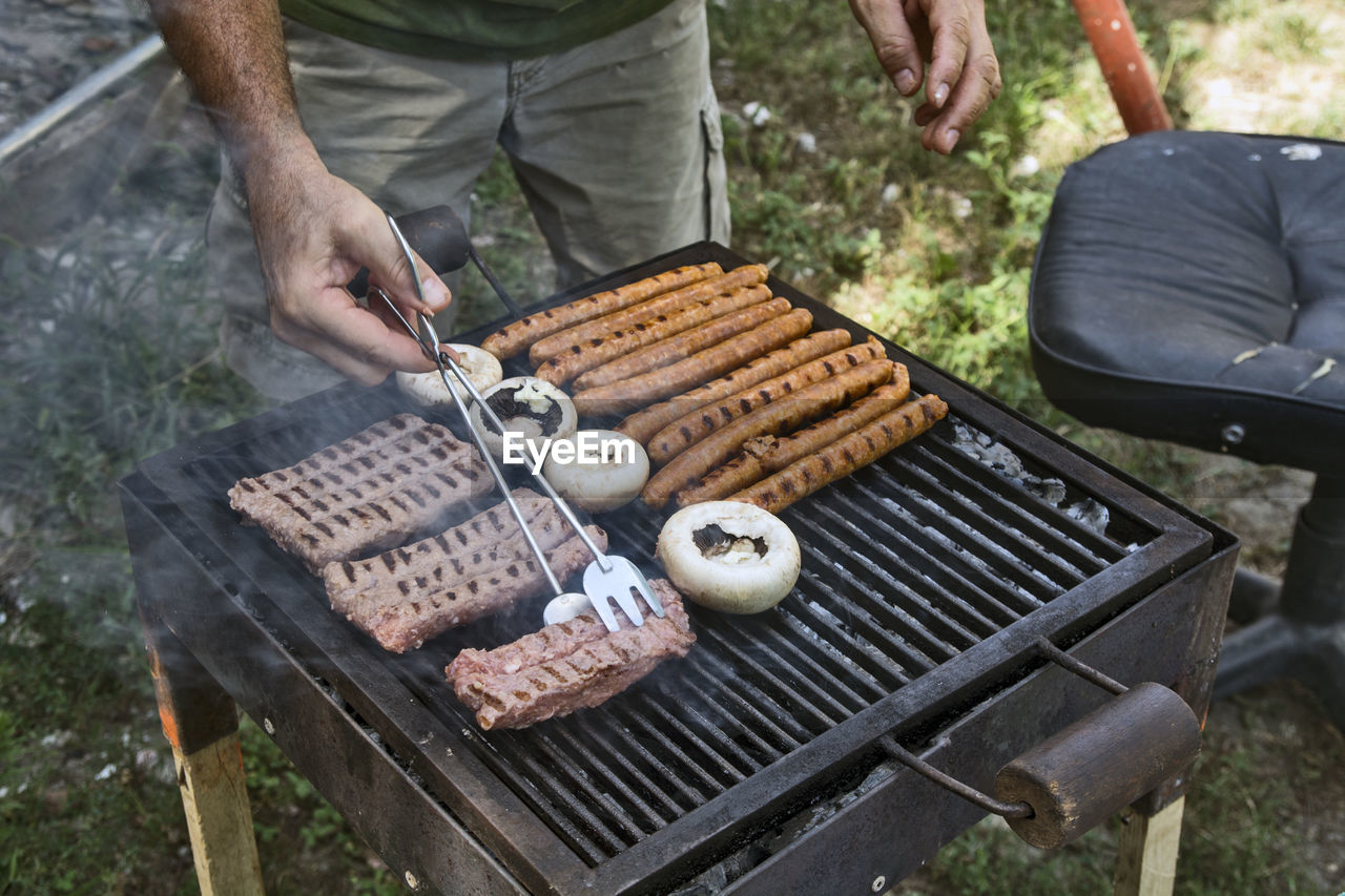 Preparing barbecue meat at picnic in nature. the meat is roasted in a conventional way.