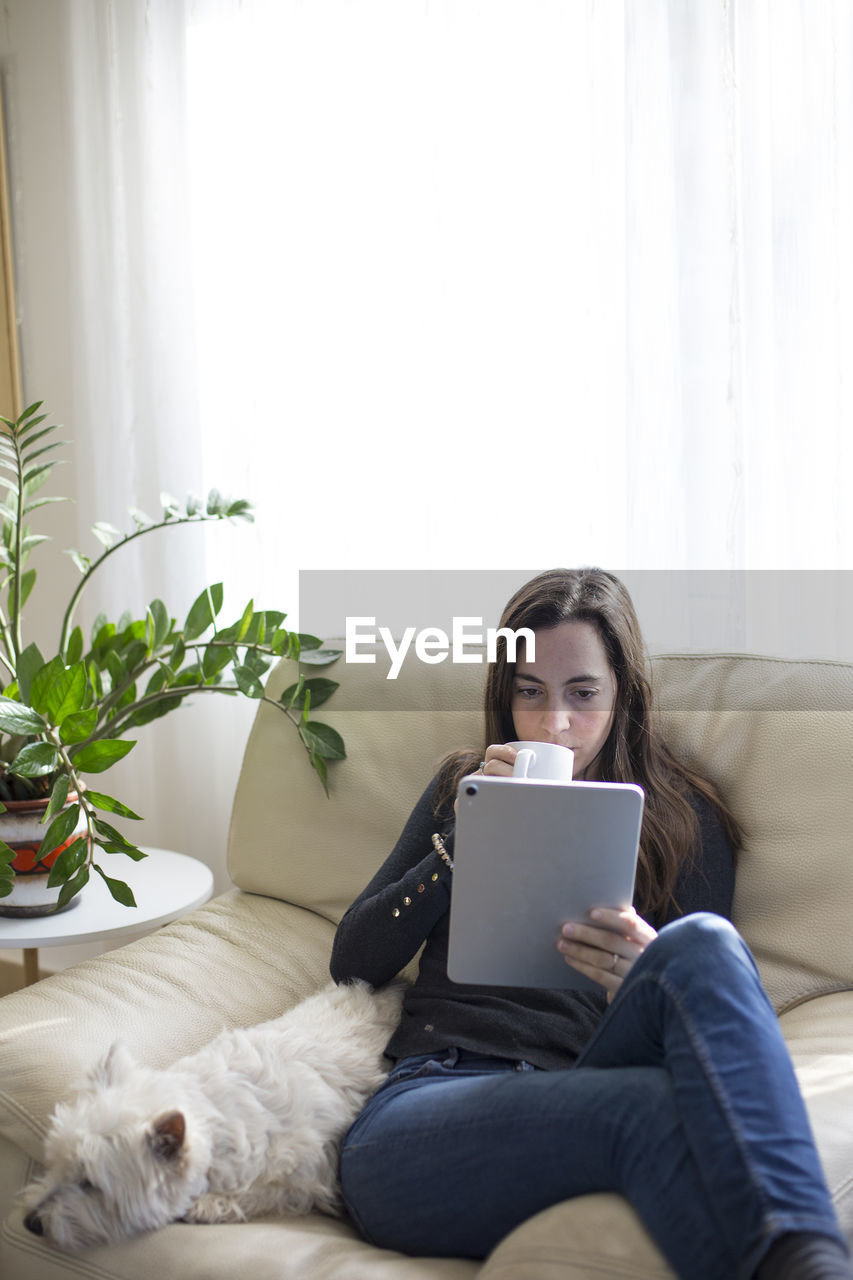 Woman sitting on sofa at home