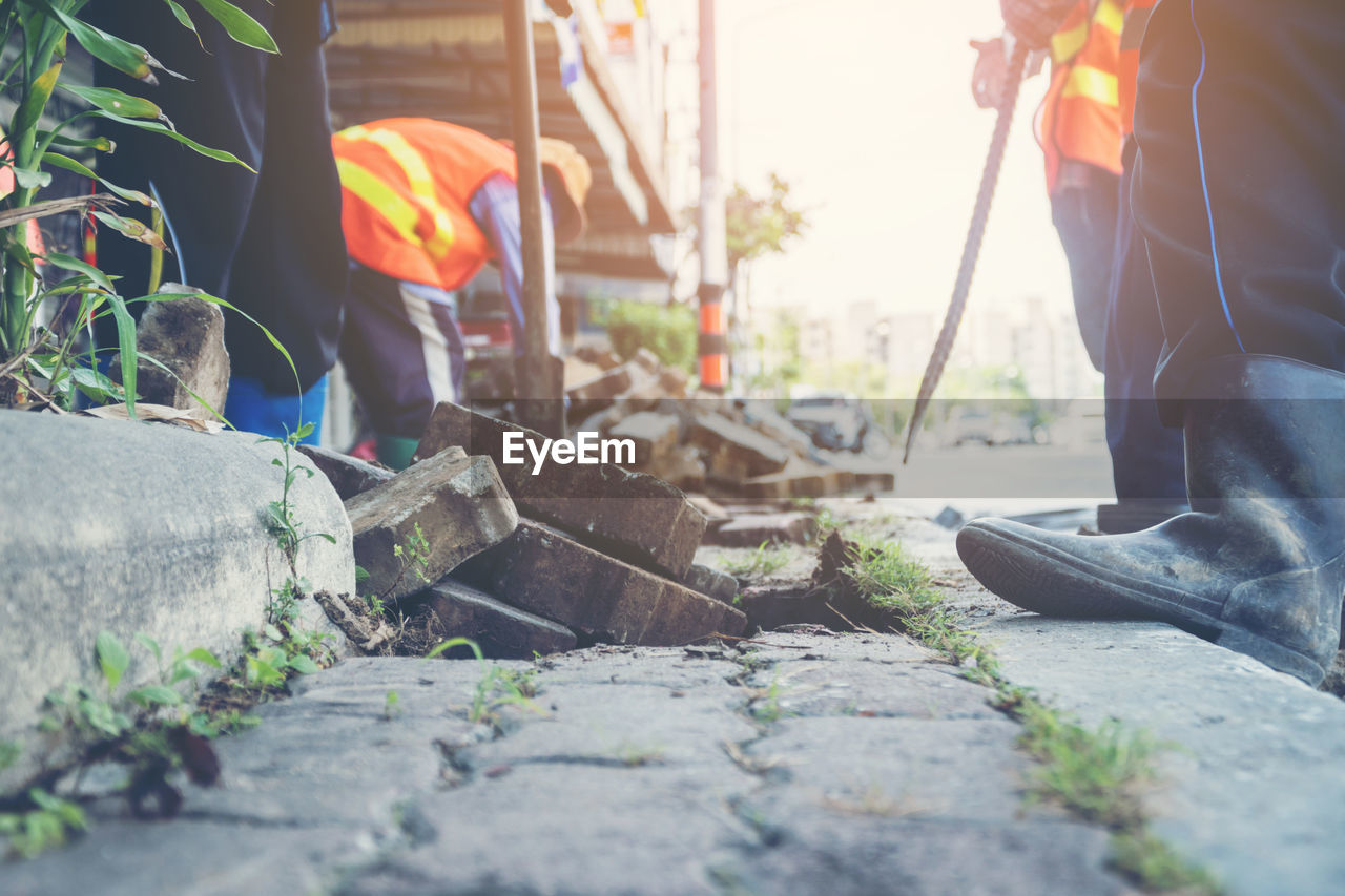 Close-up of rusty jackhammer on road at construction site