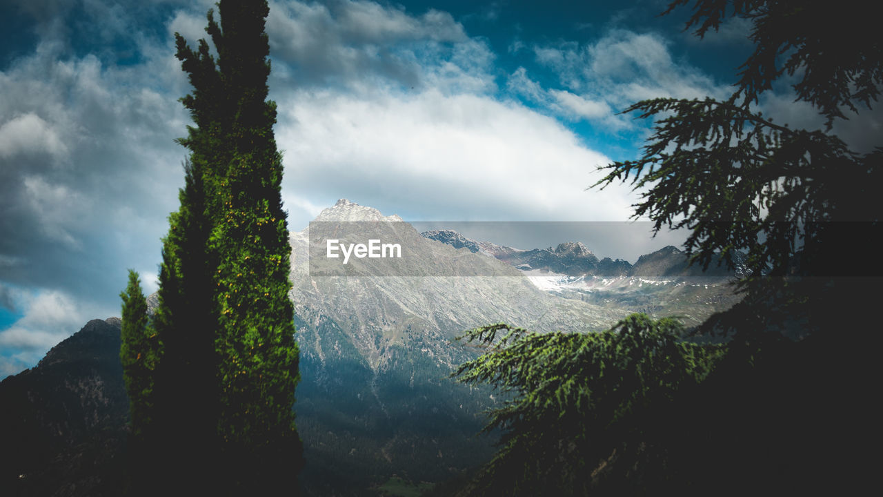 Scenic view of mountains against cloudy sky