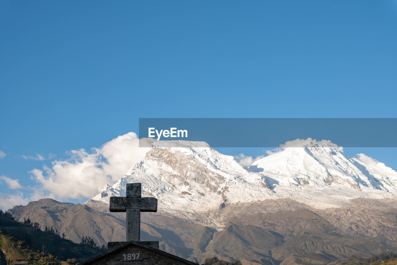 Snow-capped huascaran mountain seen from the cemetery of the town called yungay in huaraz, peru.