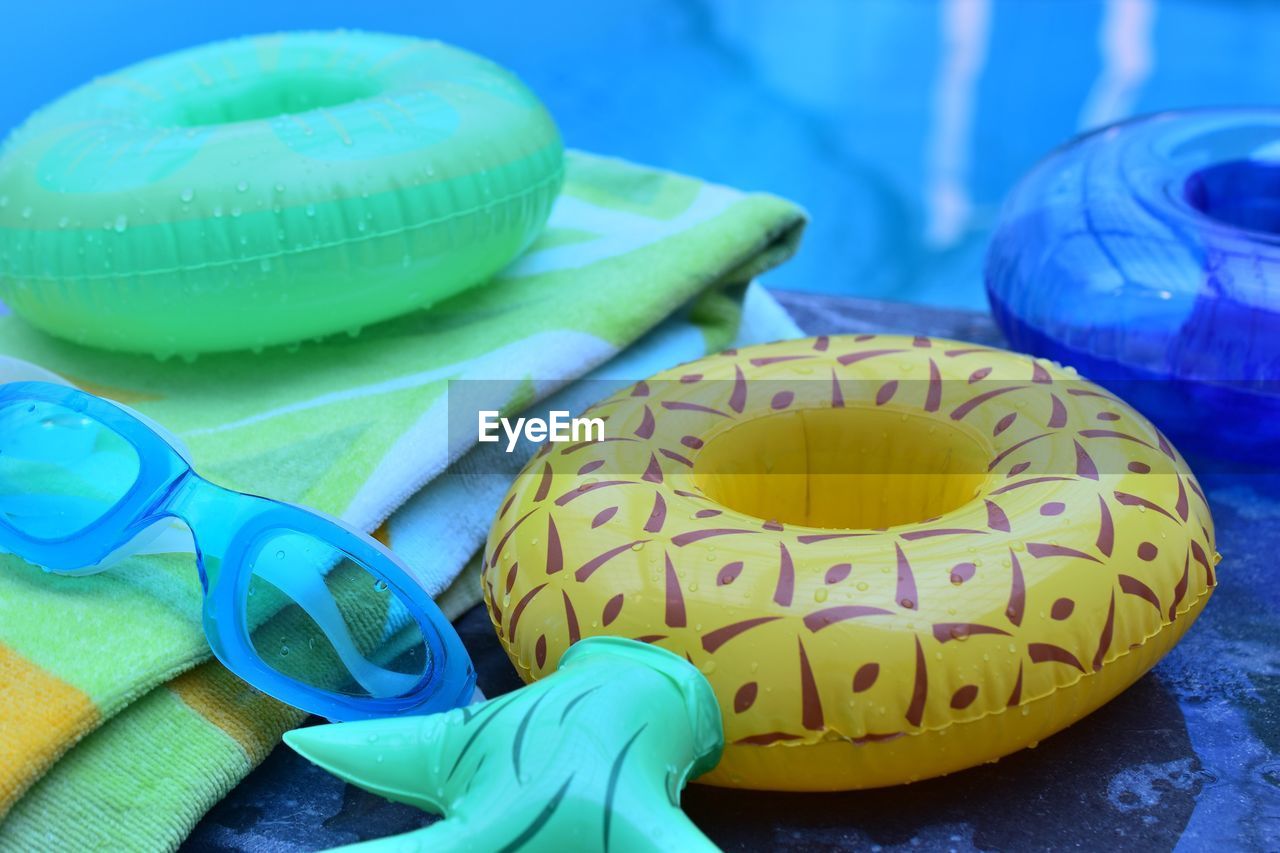 Close-up of swimming goggles and inflatable rings