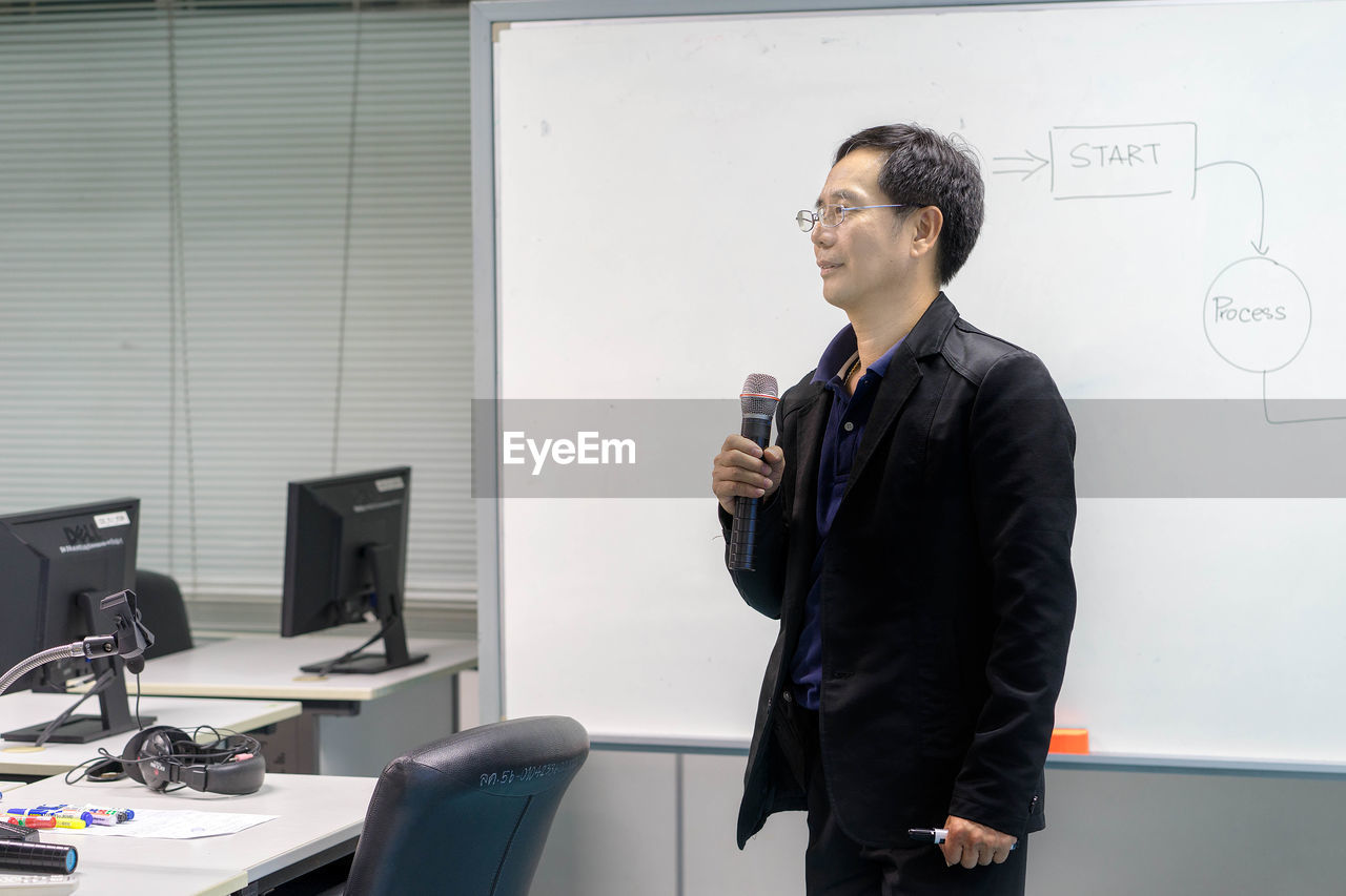 Businessman giving presentation in office