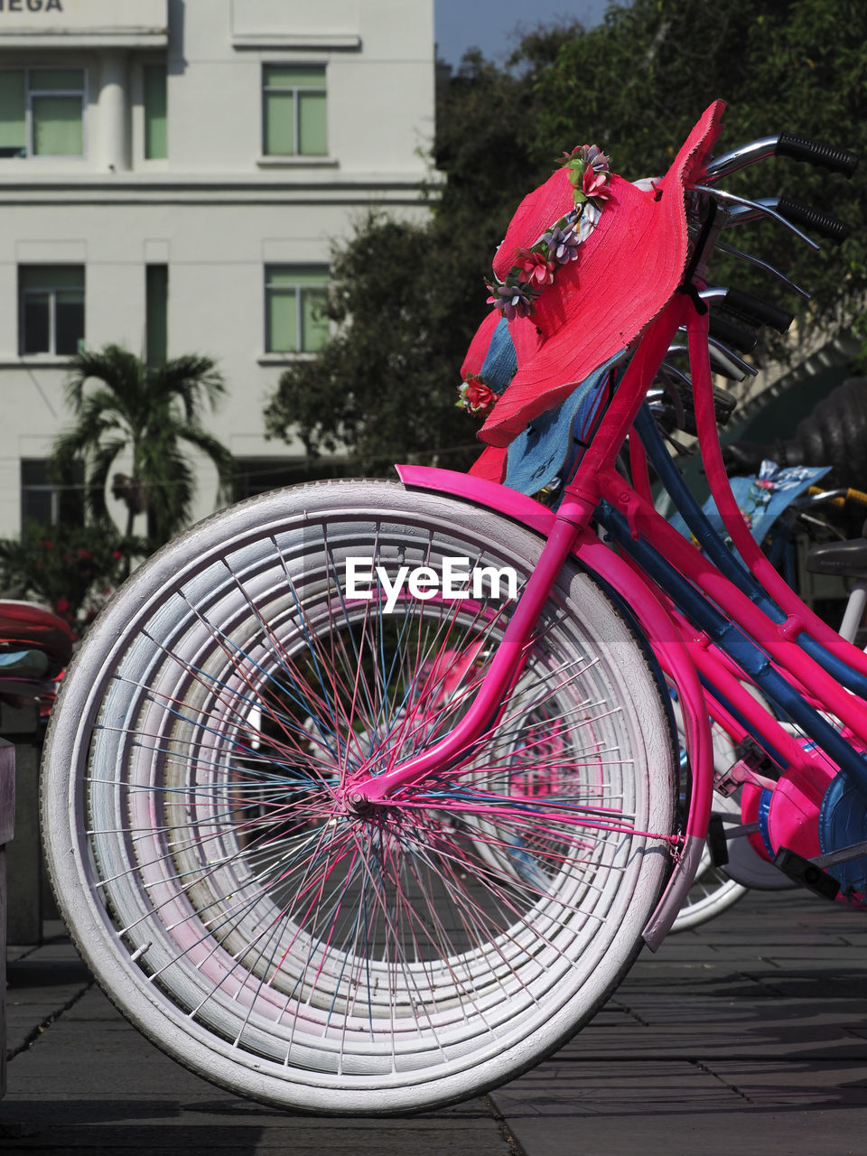 VIEW OF BICYCLE PARKED ON FOOTPATH BY BUILDING