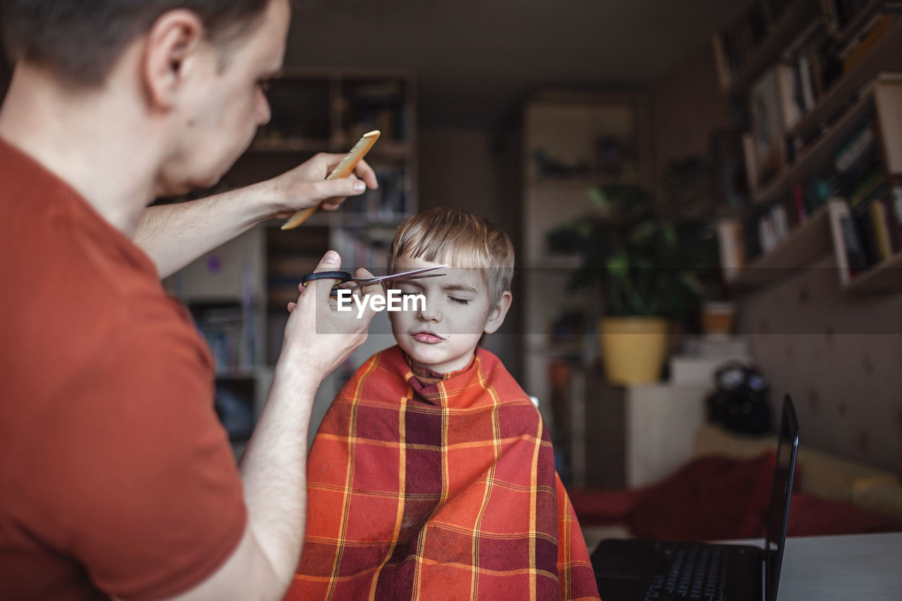 FATHER AND BOY HOLDING SON