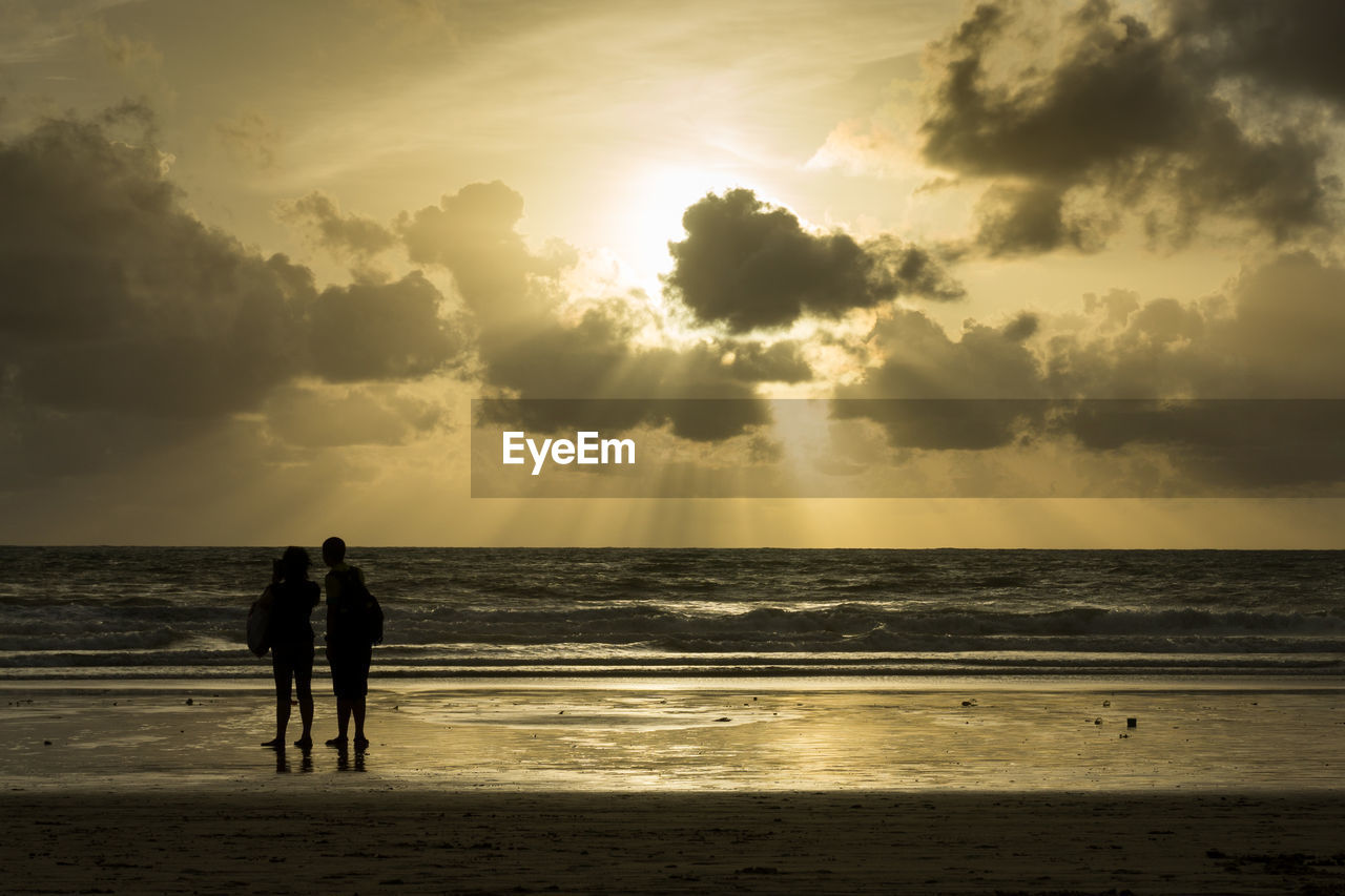 SCENIC VIEW OF CALM SEA AT SUNSET