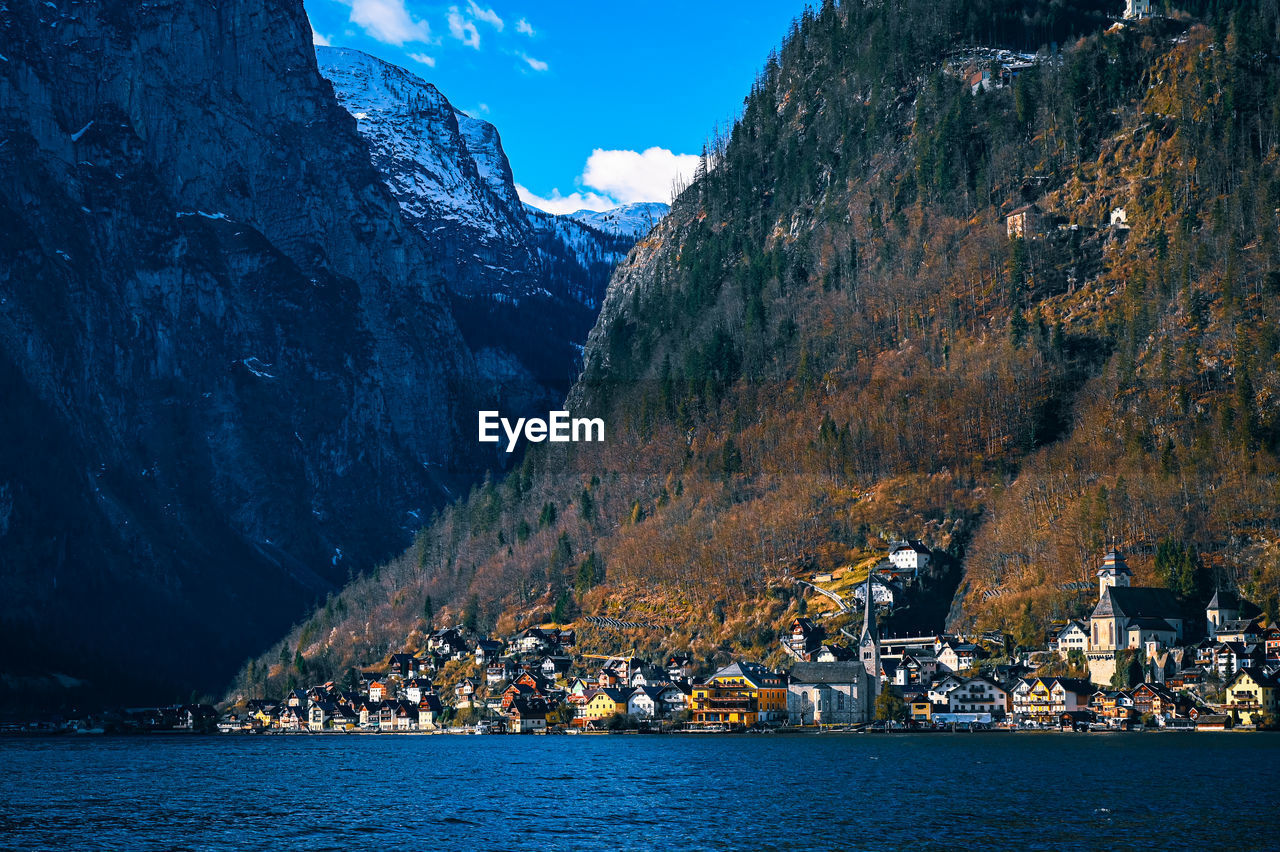 scenic view of sea by mountain against sky