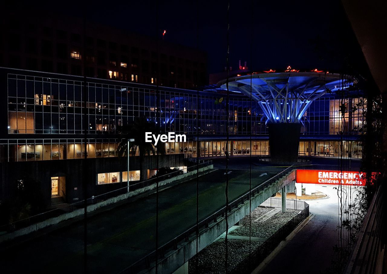 VIEW OF ILLUMINATED CITY AT NIGHT