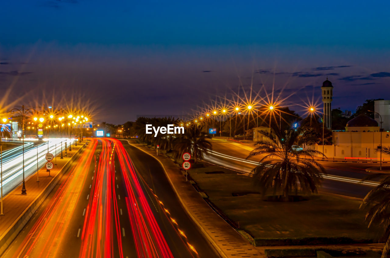 LIGHT TRAILS ON HIGHWAY IN CITY