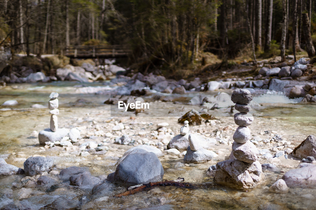 Close-up of pebbles stacked at riverbank