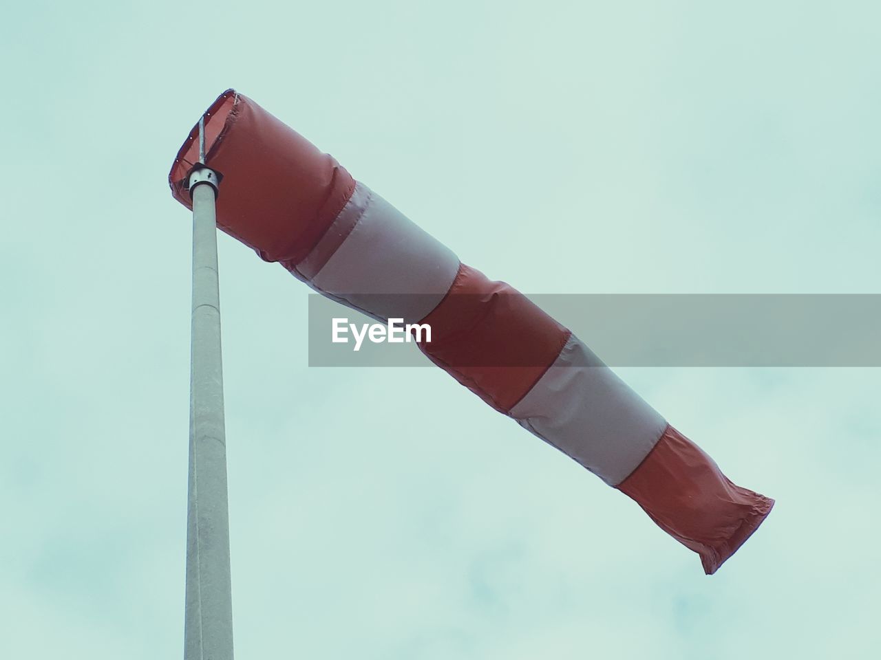 Low angle view of flags against sky