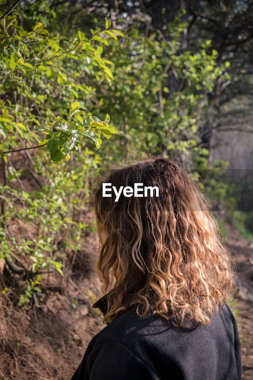 Woman standing in forest