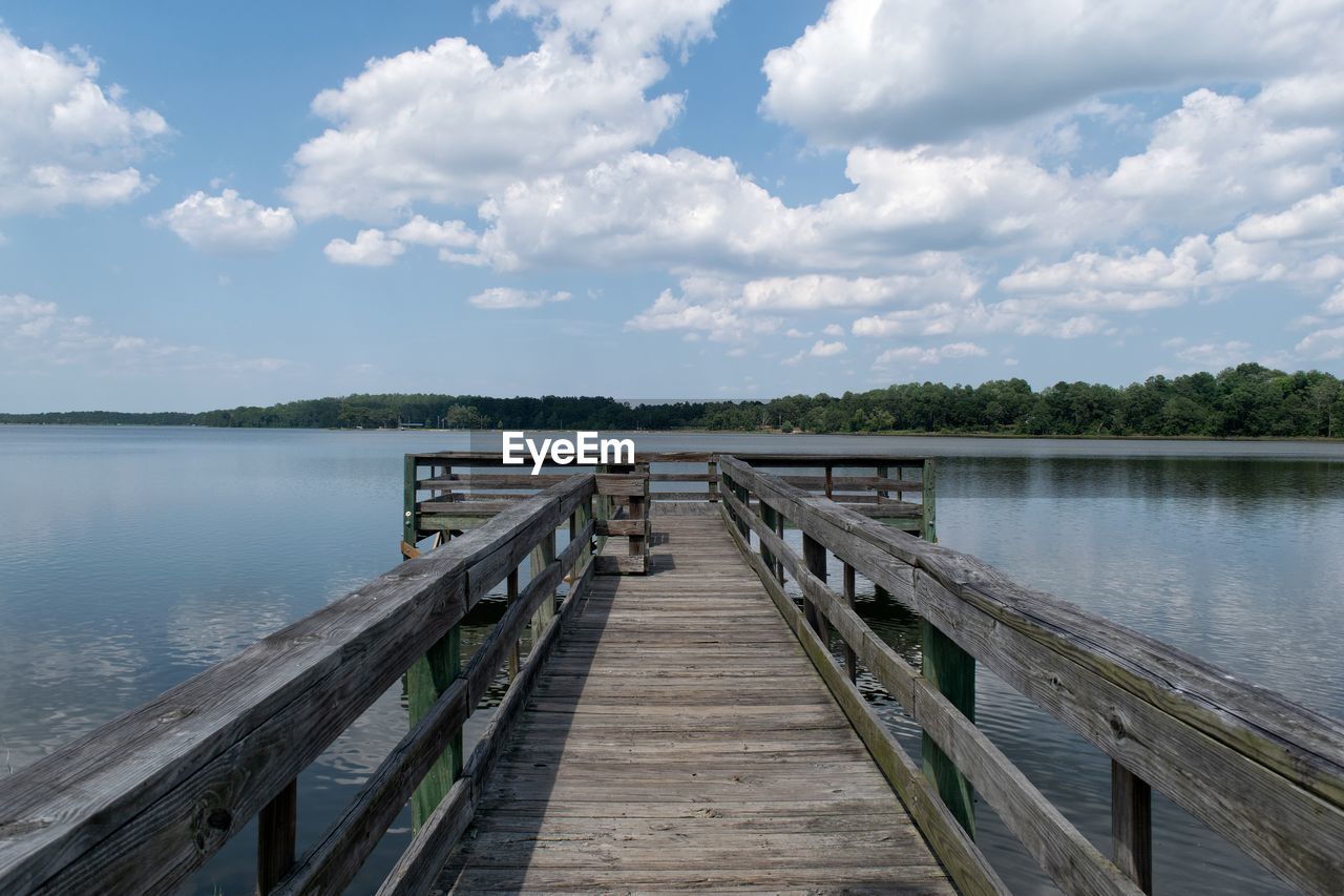 Pier over lake against sky